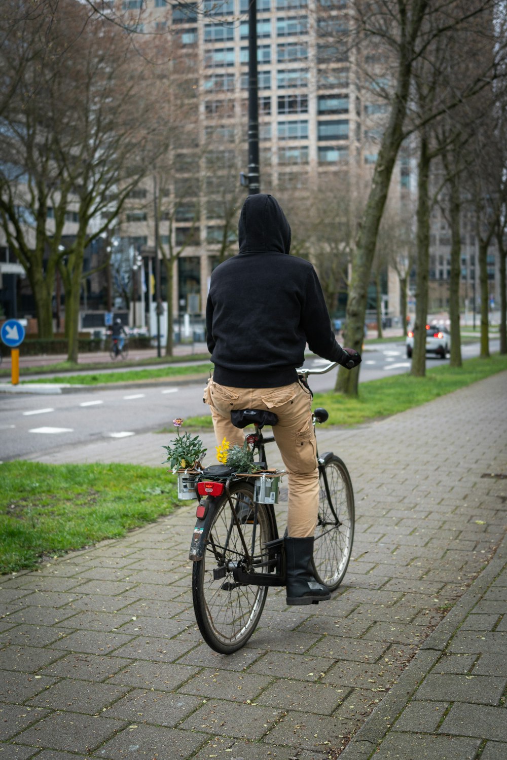 a man riding a bike down a sidewalk