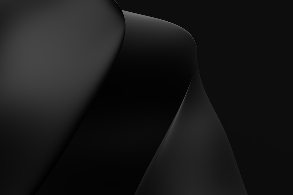 a close up of a black object with a black background