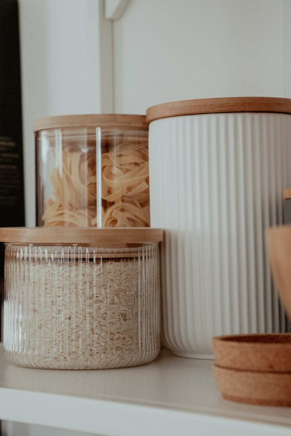a white shelf topped with containers filled with food