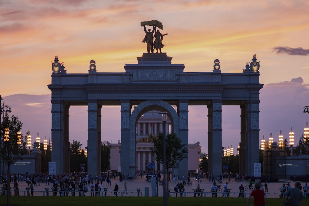 a large arch with a statue on top of it