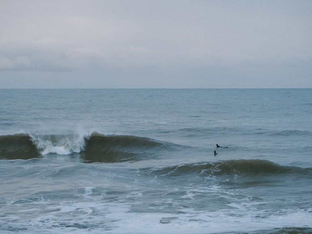 a person riding a wave on top of a surfboard