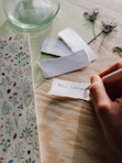 a person is writing on a piece of paper
