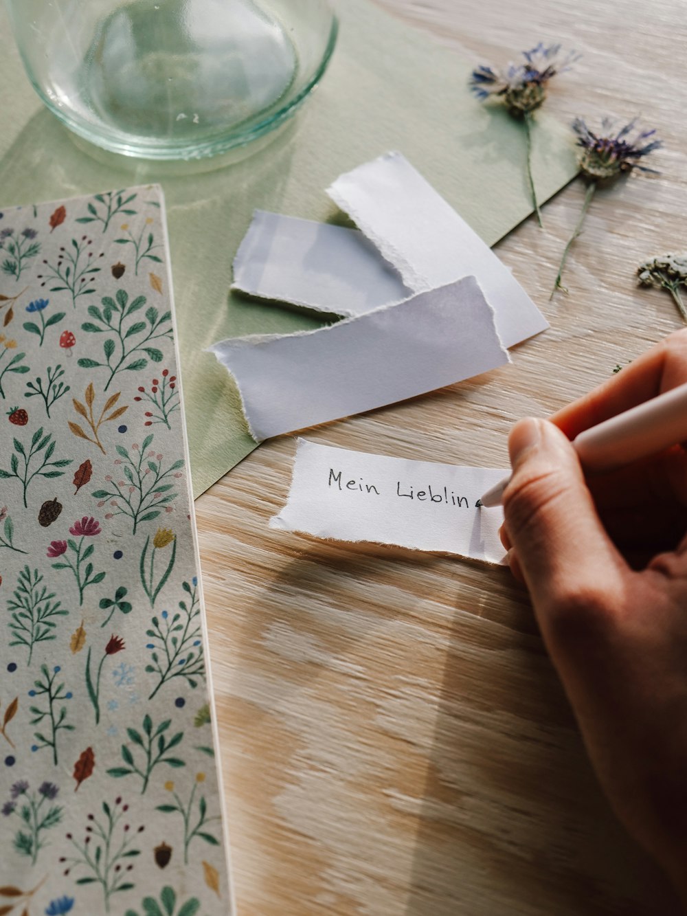 a person is writing on a piece of paper