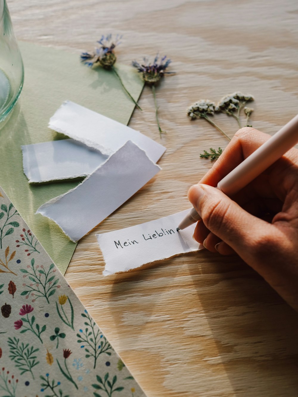 a person writing on a piece of paper