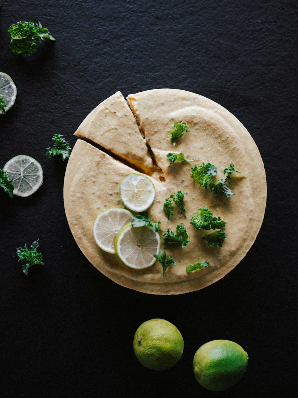 a tortilla with limes and a slice of lime