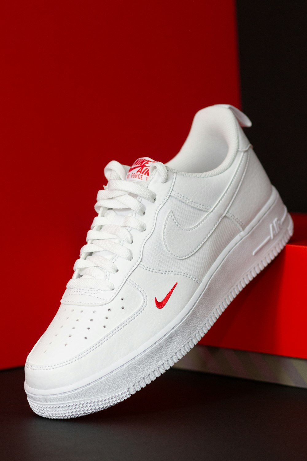 a pair of white nike air force sneakers