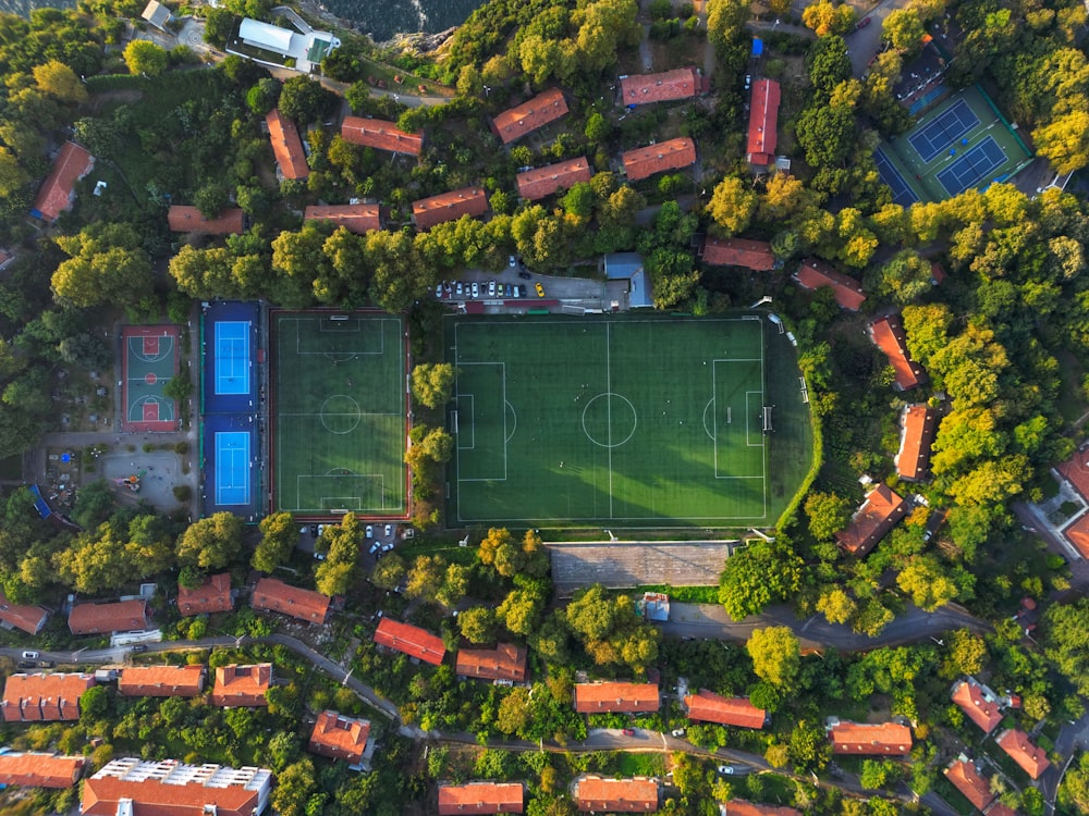 an aerial view of a soccer field surrounded by trees