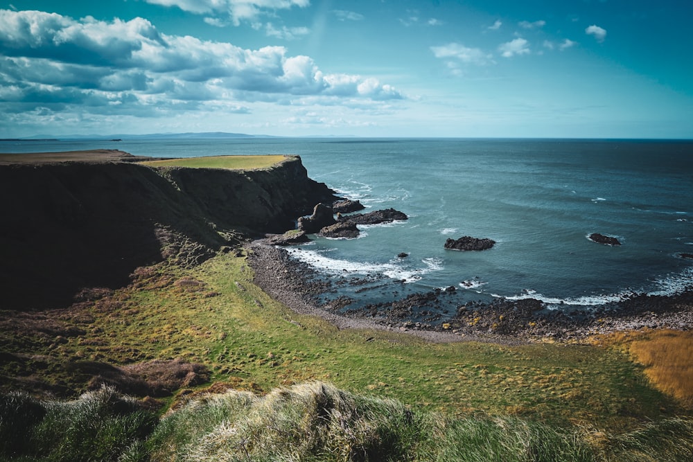 a view of the ocean from the top of a hill