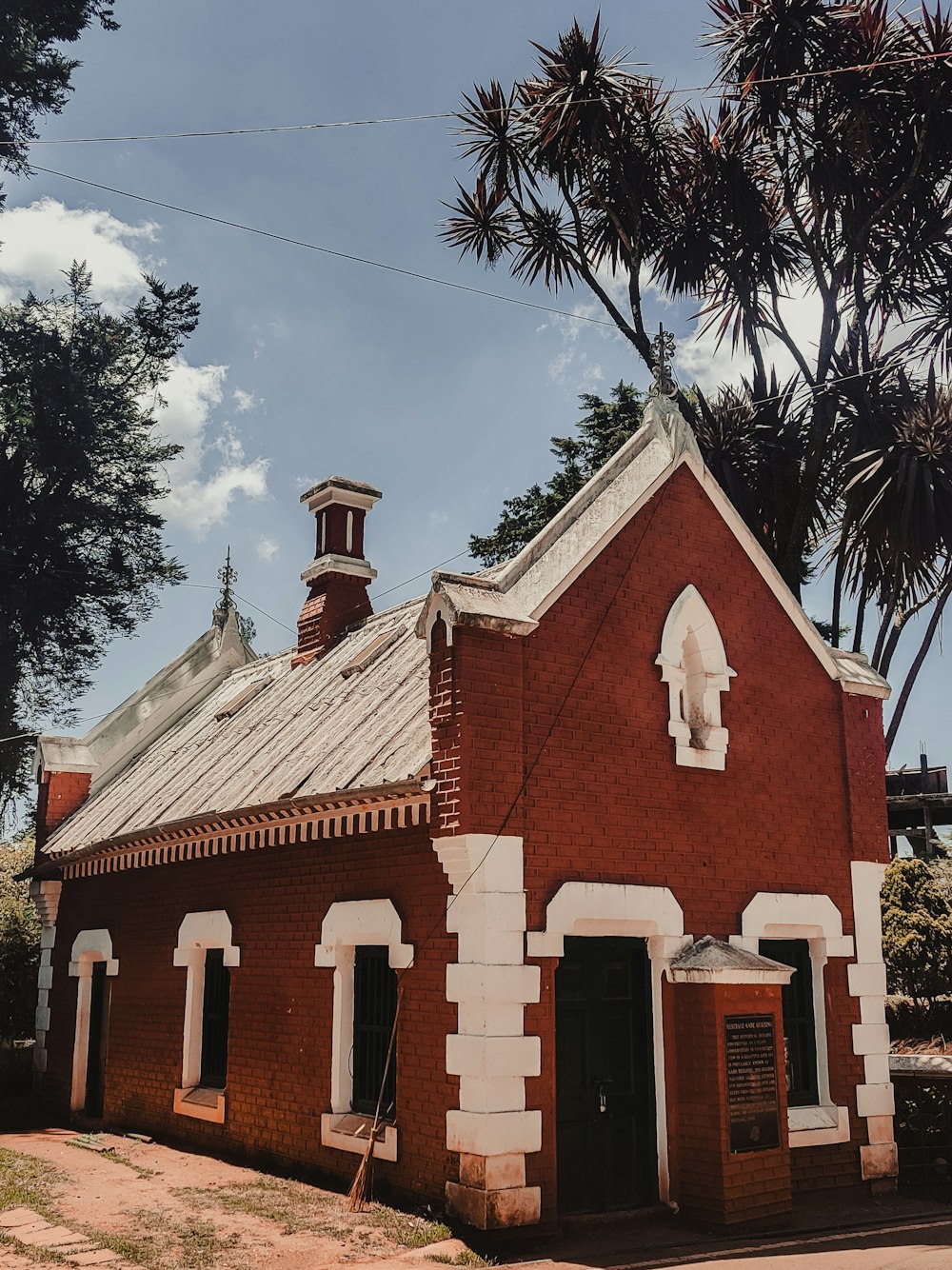 a red brick church with a steeple and a clock tower