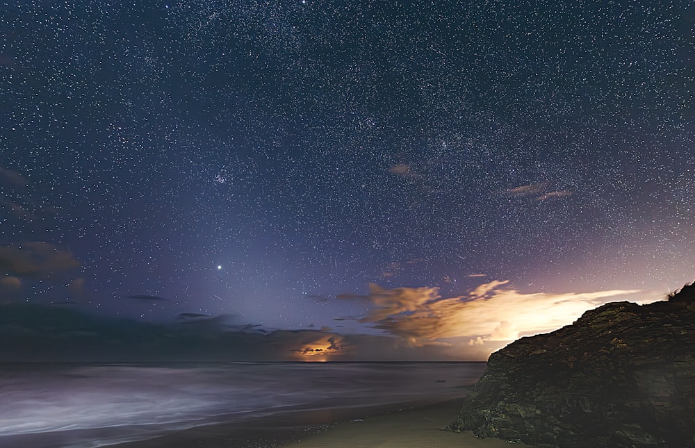 the night sky is filled with stars and clouds