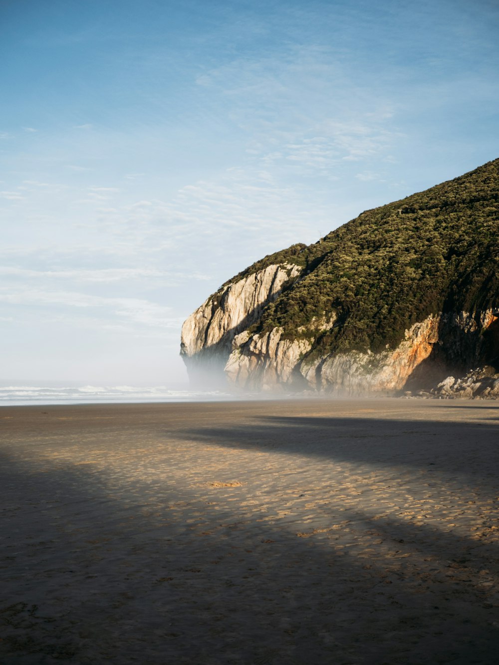 a person riding a surfboard on a sandy beach