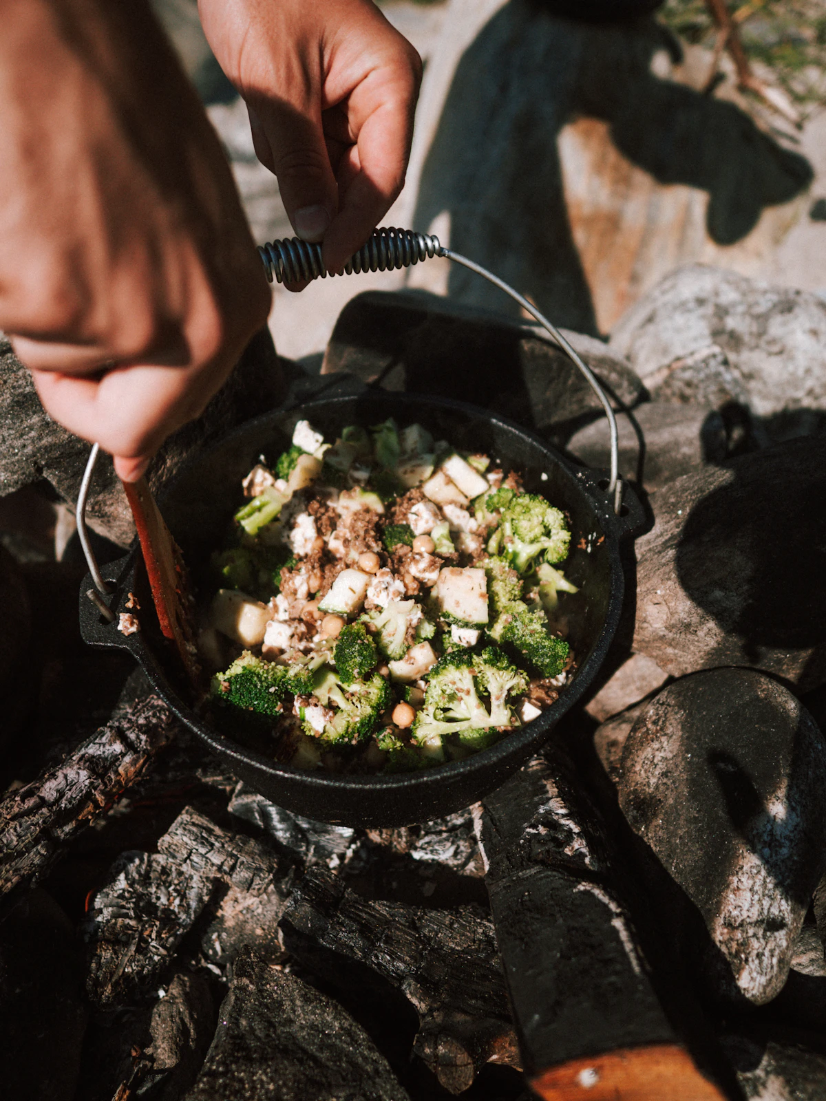 Simple camp meal cooking over a small stove outdoors