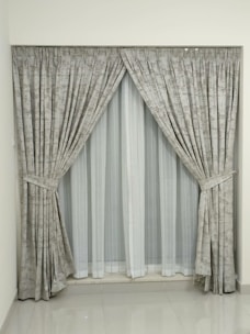a window with a curtain and a window valance