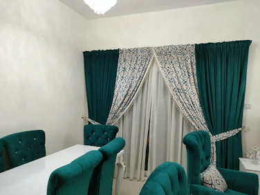 a dining room with green chairs and a white table