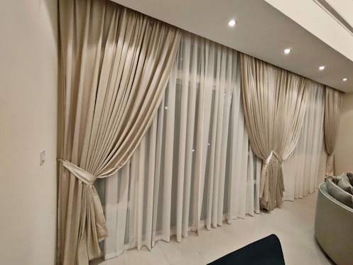 a living room filled with furniture and curtains