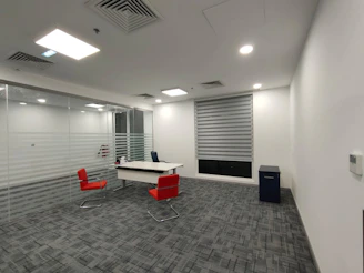 an empty office with a desk and chairs