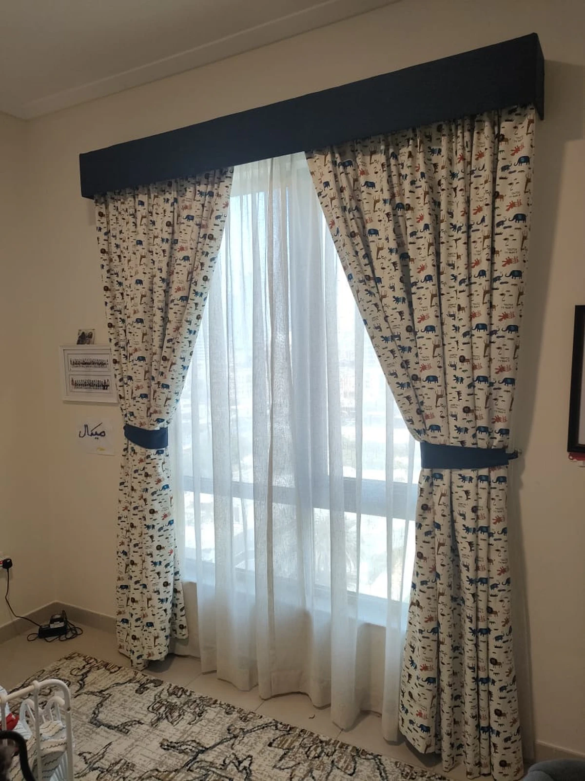 Curtain track and pelmet fitted above a dressed window
