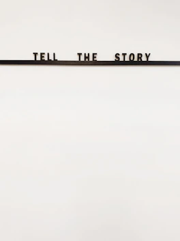 a sign that says tell the story on it