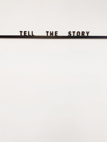 a sign that says tell the story on it