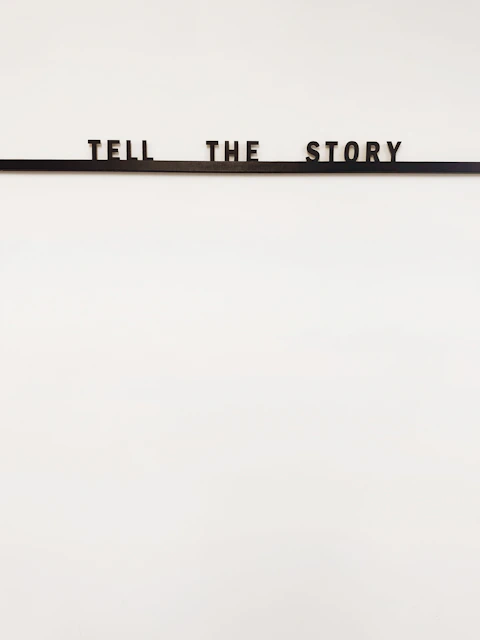 a sign that says tell the story on it