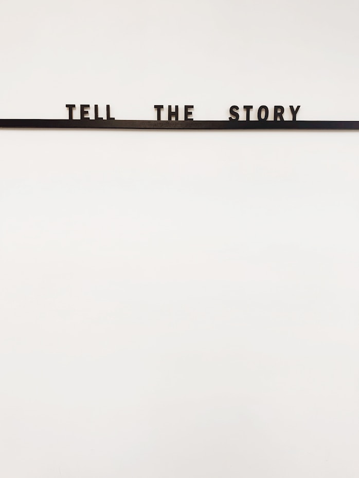 a sign that says tell the story on it