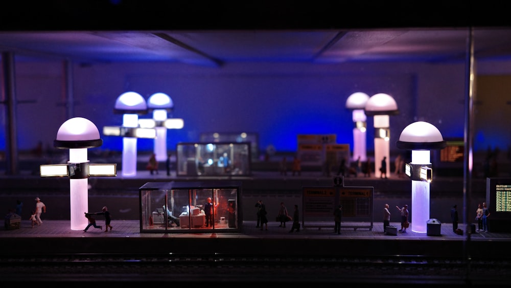 a model of a train station with people walking around