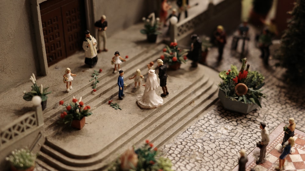 a group of figurines that are standing on a set of steps