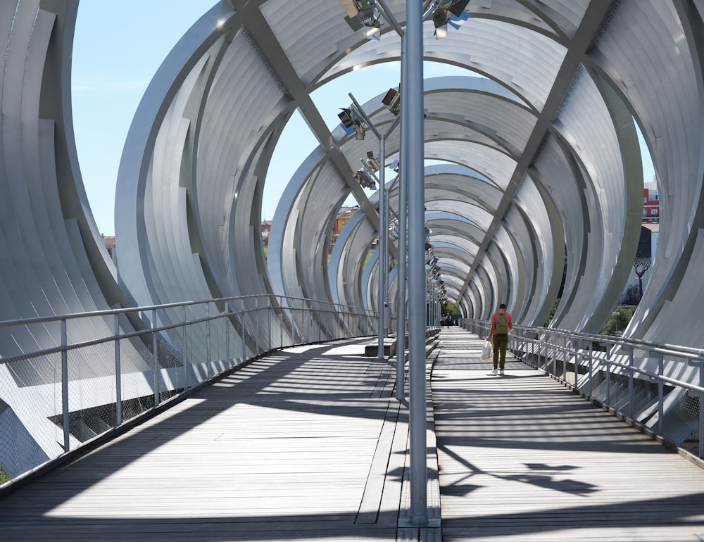 a person walking across a bridge over a river