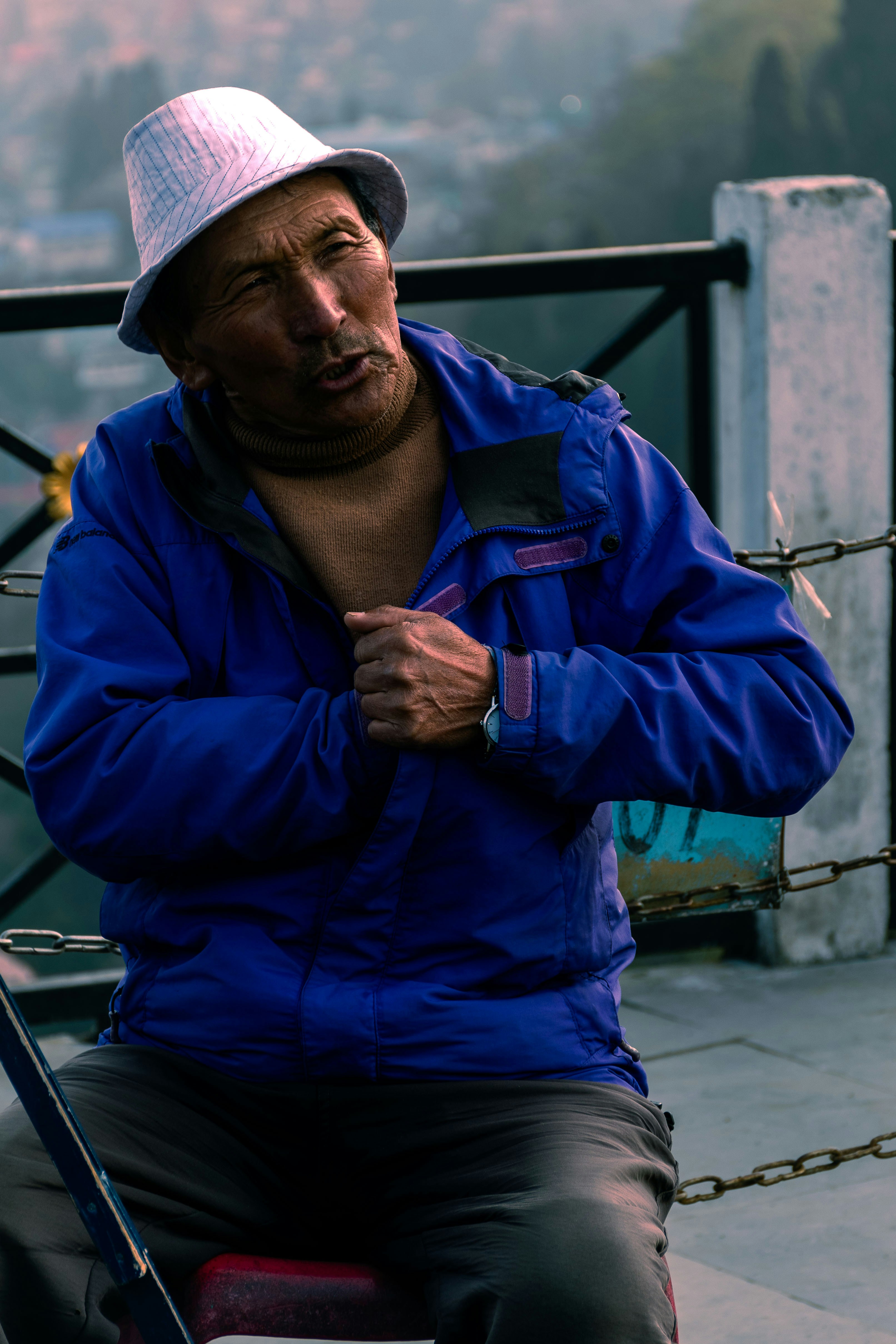 a man sitting on a bench with a fishing pole