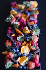 a long tray of fruit on a table