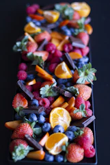 a long tray of fruit on a table