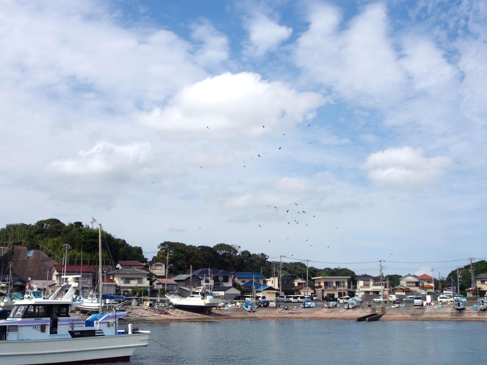 a harbor filled with lots of boats under a cloudy blue sky