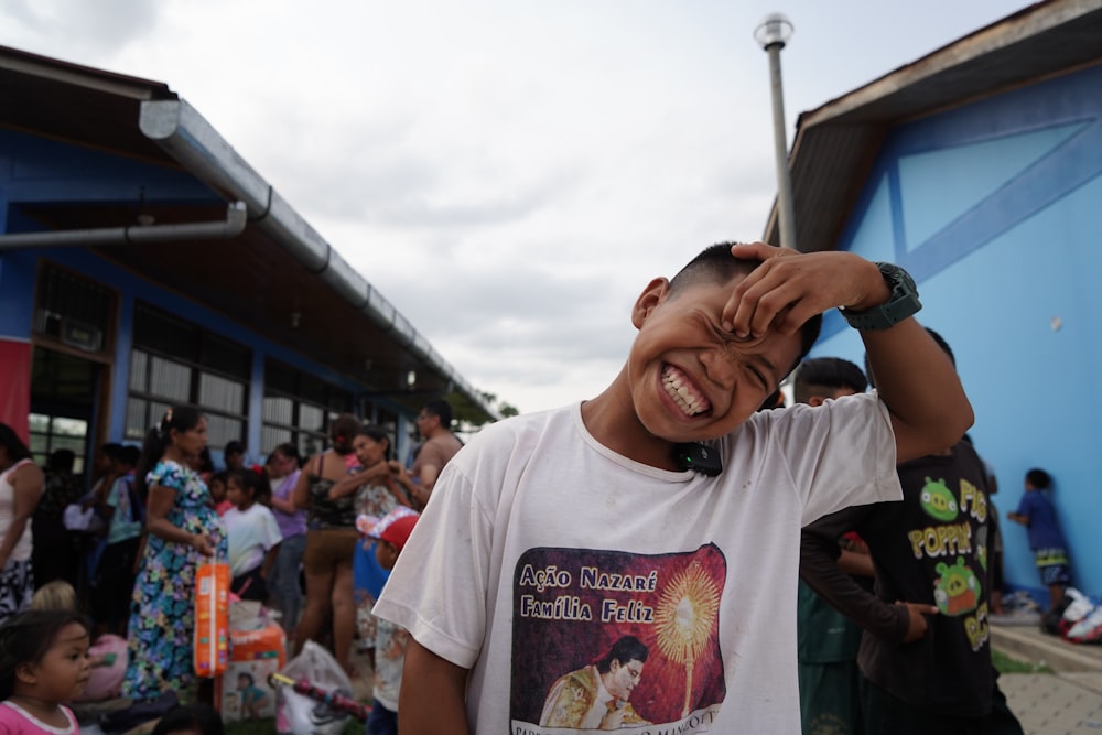 a young man is covering his eyes with his hands