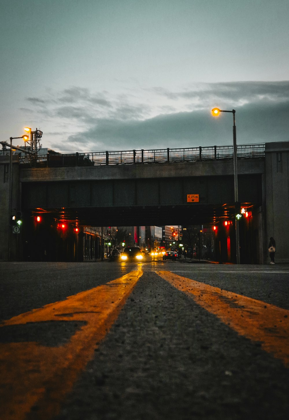 a street with traffic lights and a bridge over it