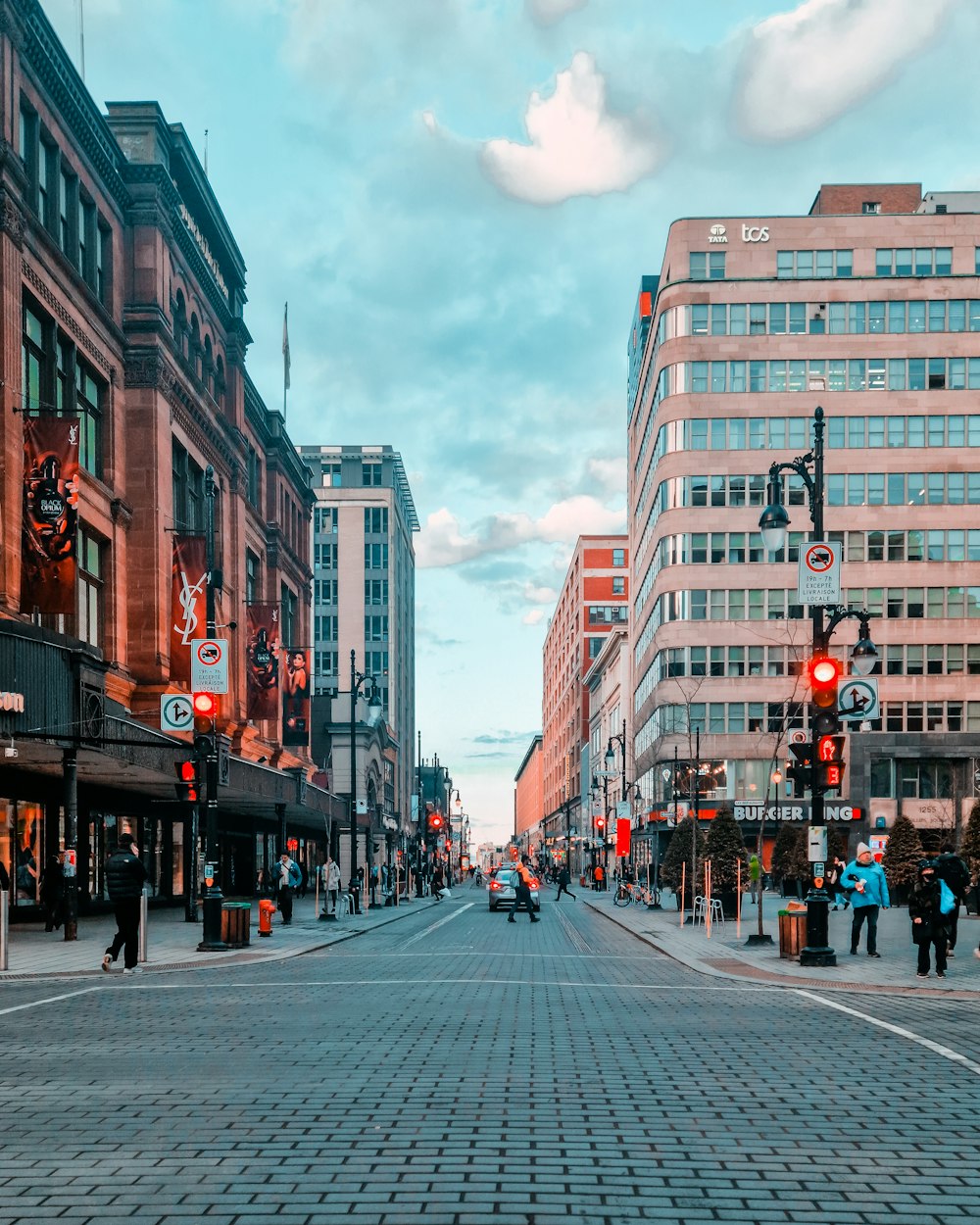 a city street with people walking on the sidewalk