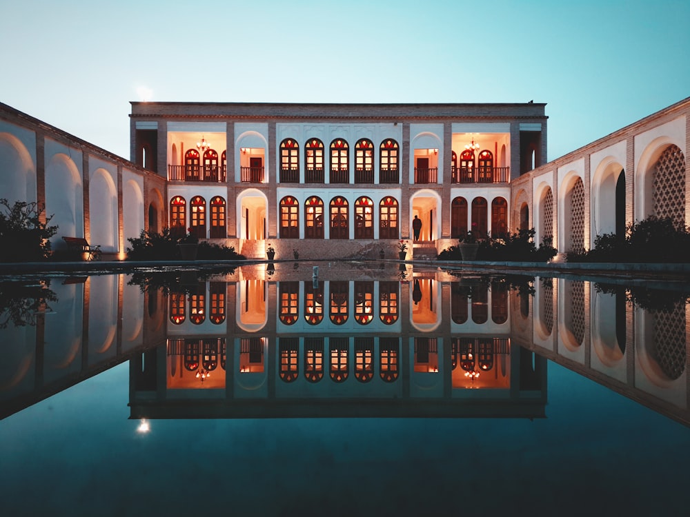 a large building with a pool in front of it