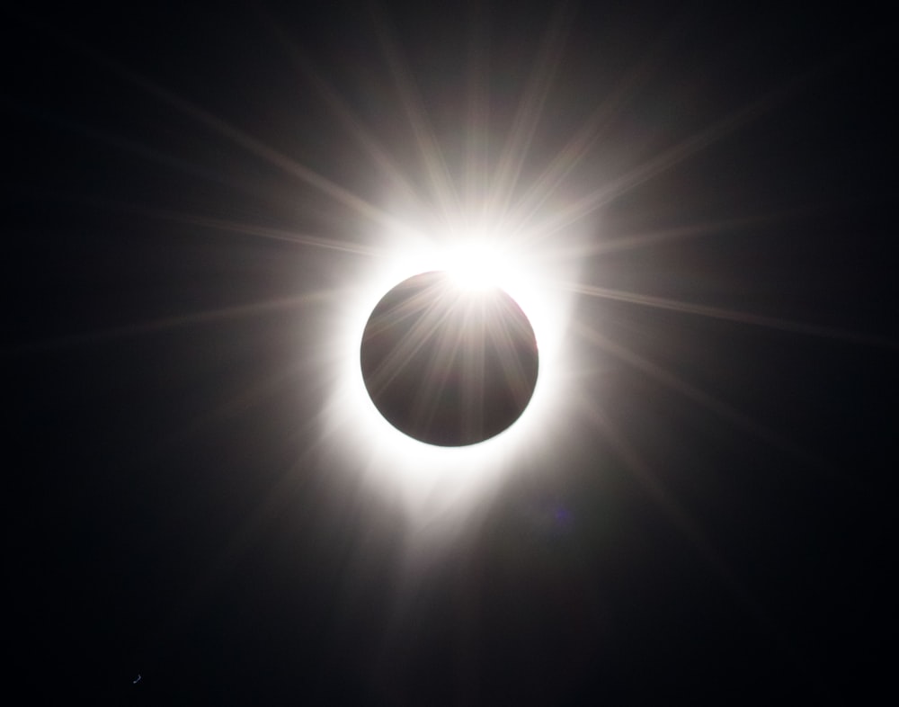 a solar eclipse is seen in the dark sky