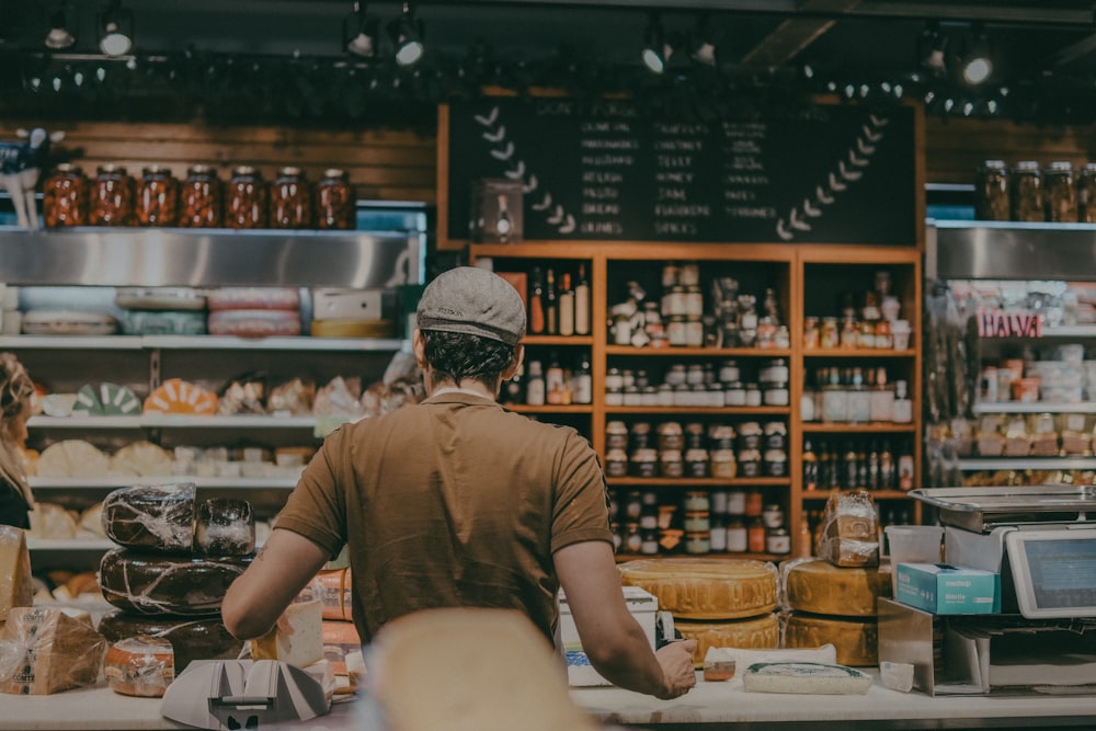 a man standing behind a counter in a store