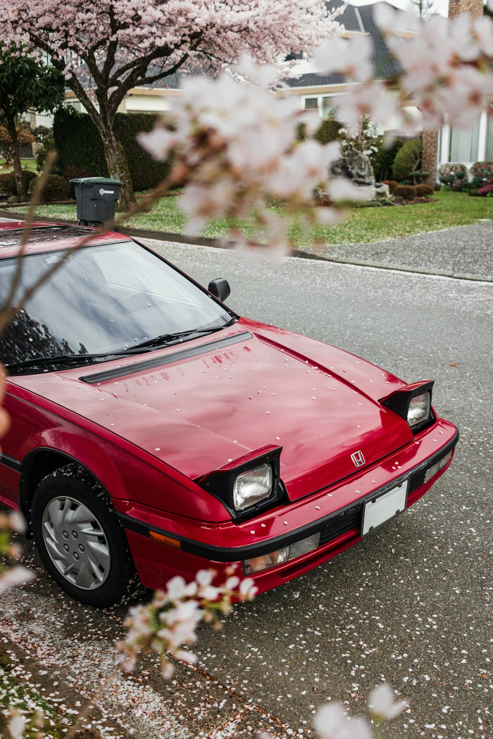 a red car parked on the side of the road