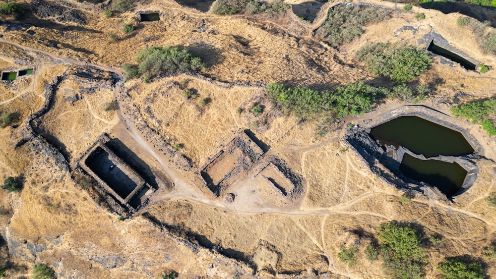 an aerial view of a large structure in the middle of a forest