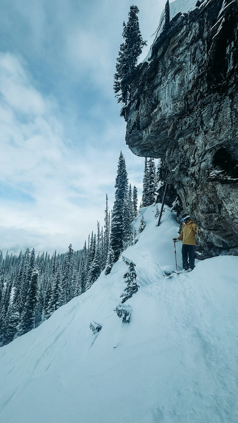 a man standing on top of a snow covered slope