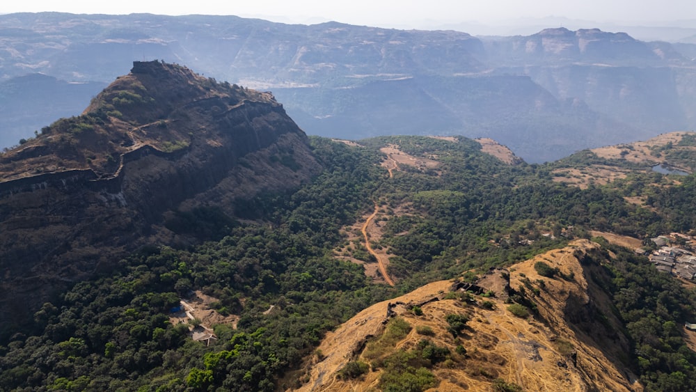 a scenic view of a mountain range with a river running through it