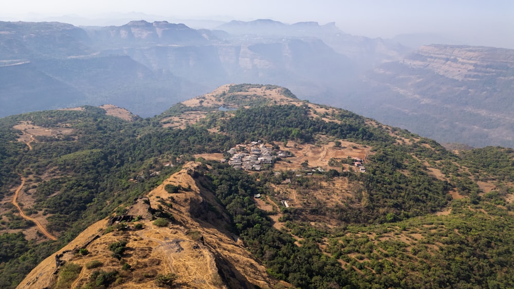 an aerial view of a mountain with a village on it