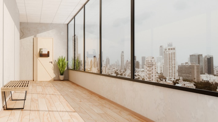 a room with a bench and a large window