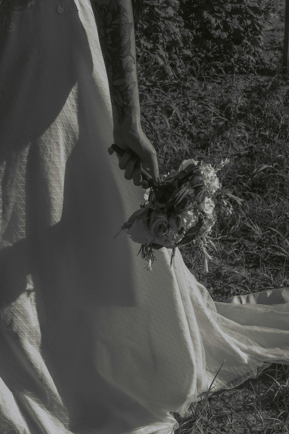 a person in a dress holding a bouquet of flowers