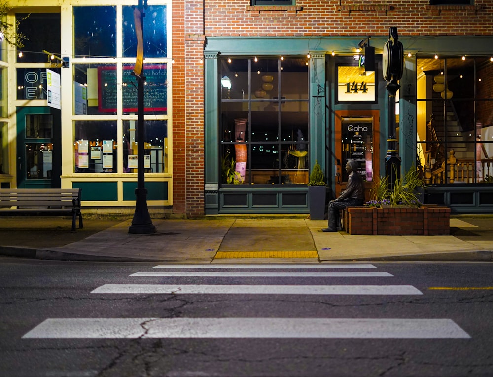 a street corner with a store front at night