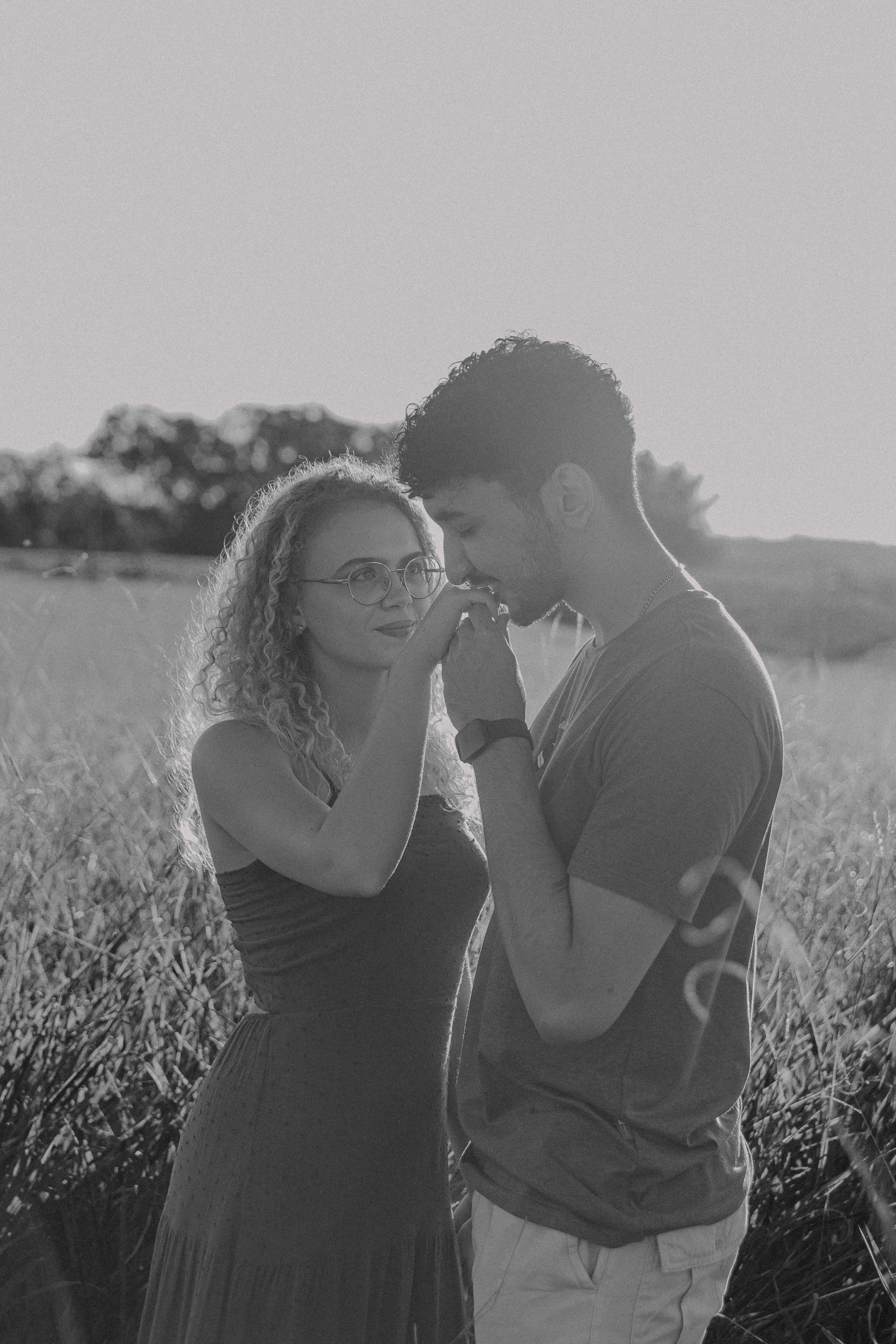 a man and a woman standing in a field