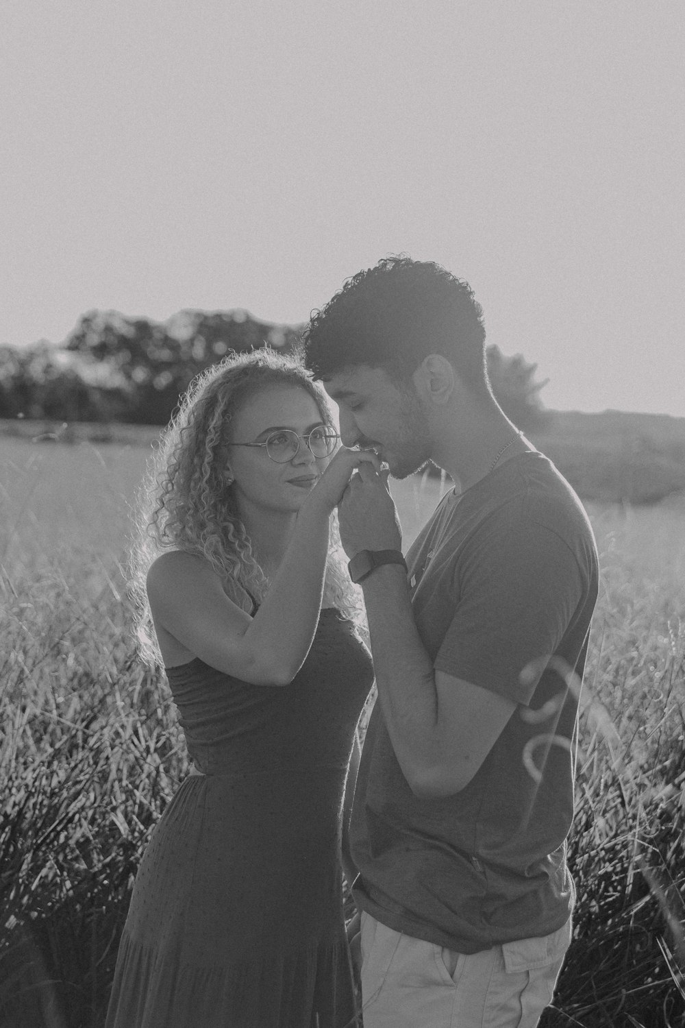 a man and a woman standing in a field