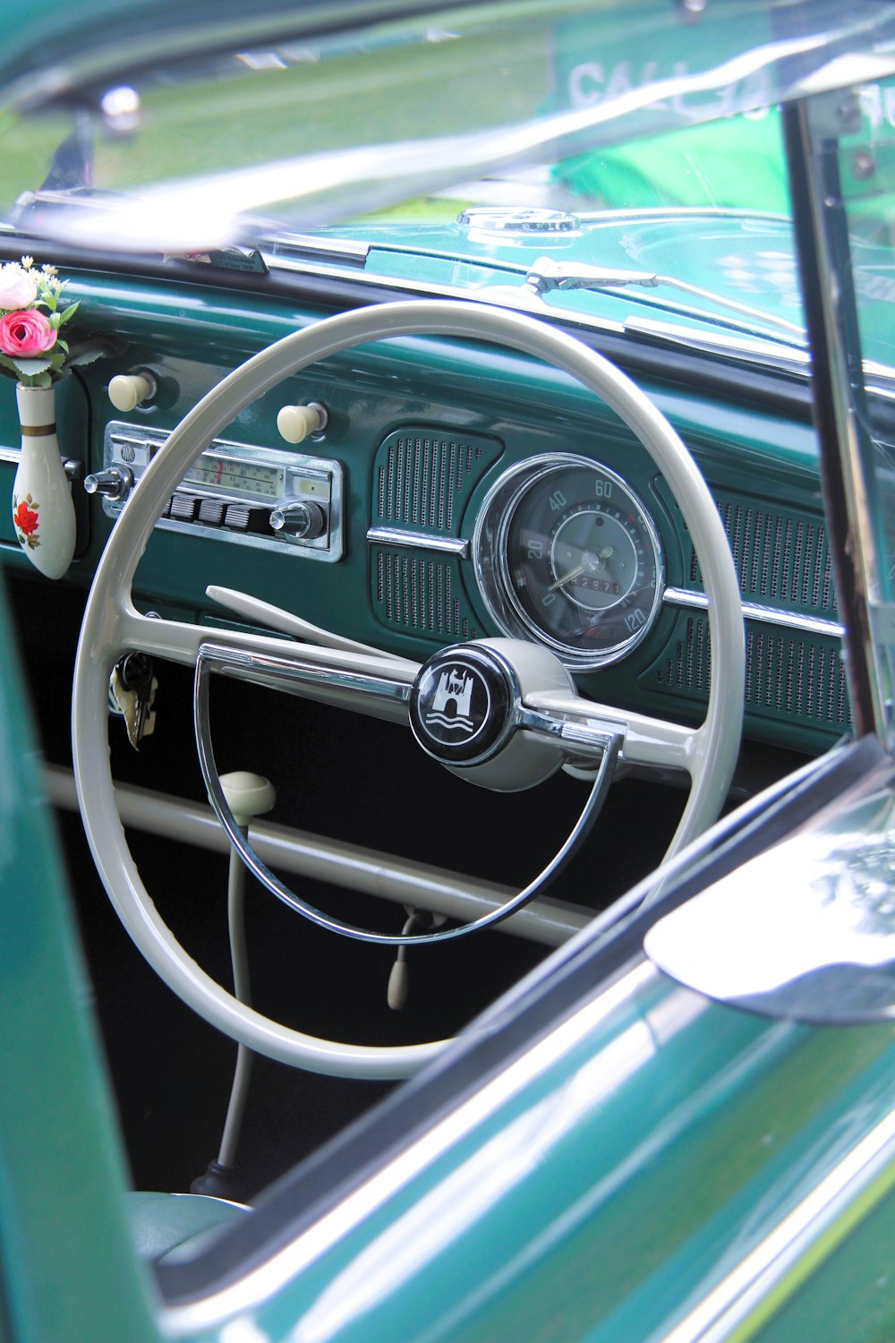 a green car with a steering wheel and dashboard