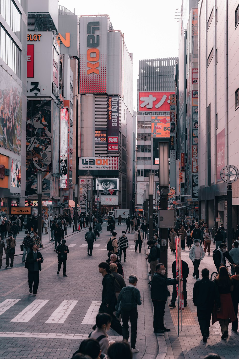 a crowded city street filled with lots of people